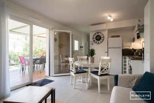 une cuisine et un salon avec une table et des chaises dans l'établissement Villa T3 à 400m de la plage avec piscine, à Vias