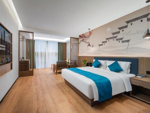 a hotel room with a bed and a tv at Mehood Lestie, Nanjing Olympic Sports in Nanjing