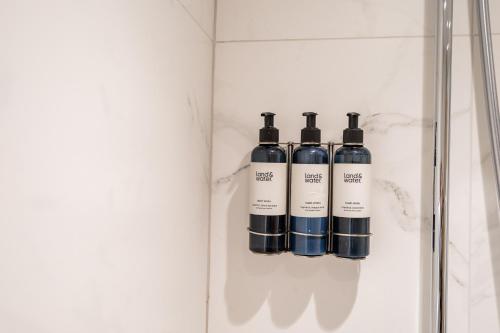 a group of four bottles on a shelf in a bathroom at Town Center Duplex 6 in Harrogate