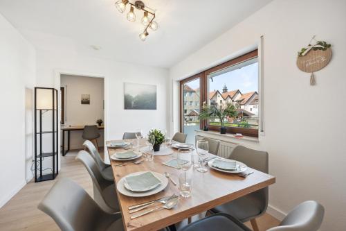 a dining room with a table and chairs at Sali Homes Weingenuss Eichbrunnen - Zentral in Obersulm