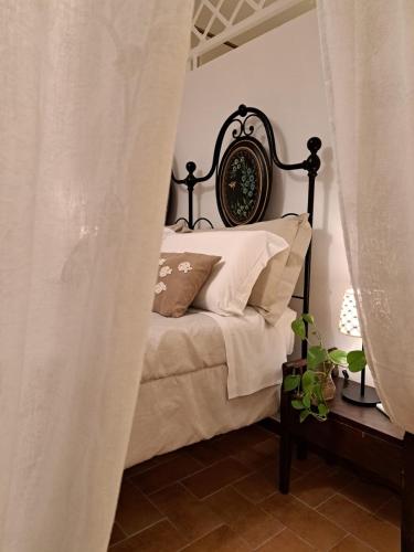 a bedroom with a bed with a black frame at Nel vicolo dei Baci - Casa vacanze al Bacio in Spello