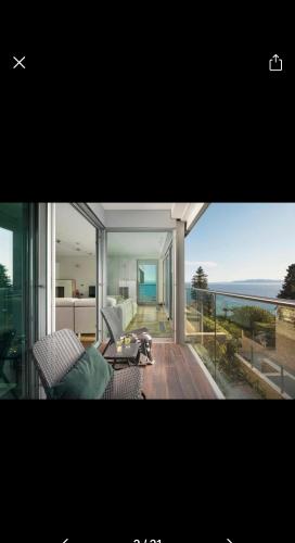 a living room with a balcony with a view of the ocean at Queen of Opatija in Opatija