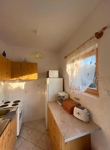 a kitchen with a sink and a stove top oven at Apartment Balatonfenyves in Balatonfenyves