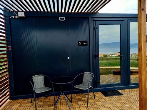 two chairs and a table in front of a building at Od svitanja do sumraka in Golubac