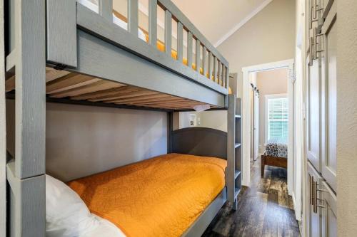 a small bedroom with a bunk bed and a staircase at Riverfront Tiny House with Fire Pit in Seguin, Texas in Seguin