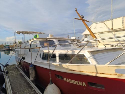 a red and white boat parked at a dock at Evasion Romantique sur le Rhône in Valence