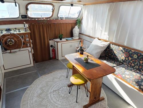 a caravan with a table and a kitchen in it at Evasion Romantique sur le Rhône in Valence