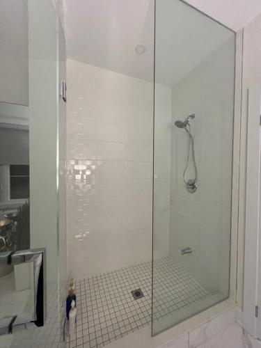 a shower with a glass door in a bathroom at French Style Mansion In Prestigious Angus Glen Markham in Markham