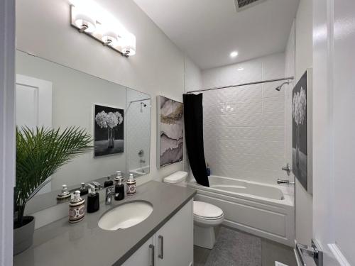 a white bathroom with a sink and a toilet at French Style Mansion In Prestigious Angus Glen Markham in Markham