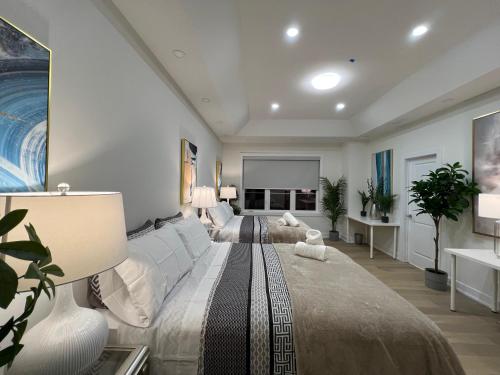 a bedroom with a large bed and a living room at French Style Mansion In Prestigious Angus Glen Markham in Markham