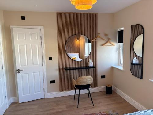 a room with a chair and a mirror at Riverside Loft Group Accommodation in Kilkenny