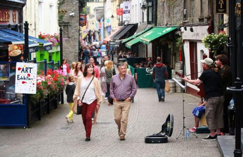 a man and a woman walking down a street at Riverside Loft Group Accommodation in Kilkenny