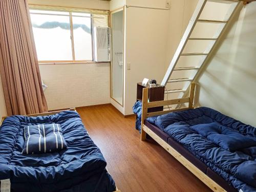 a bedroom with a bunk bed and a ladder at Guest House Ihatov - Vacation STAY 22102v in Takamatsu