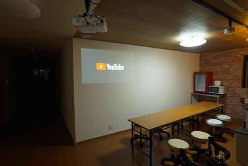 a meeting room with a table and chairs and a wall at Guest House Ihatov - Vacation STAY 22102v in Takamatsu