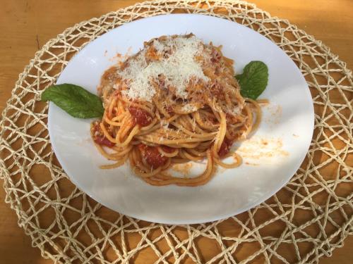 a plate of pasta with cheese and basil on a table at Kahanbu Ocean View in Thulusdhoo