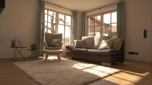a living room with a couch and a chair at Ferienwohnung Reitemann in Oy-Mittelberg