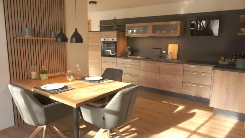 a kitchen with a wooden table and some chairs at Ferienwohnung Reitemann in Oy-Mittelberg