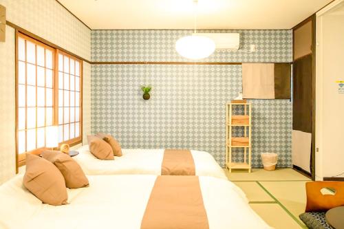 大阪市にあるLarge space FUNHOUSE-TO Big apt 9min-Namba 3min-Umeda USJの部屋にベッドが2つある寝室