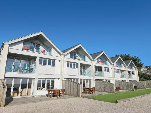 a large white building with tables in front of it at Falmouth Self Catering Lodges in Falmouth