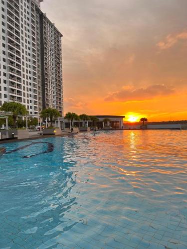 a pool in the middle of a city with a sunset at Luxury Studio at D Secret Garden - Johor Bahru, UTM, Setia Tropika, Kempas, Paradigm Mall, Mid Valley- 1-3 Pax, Business Trip Welcome in Johor Bahru