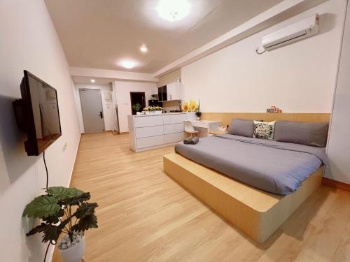 a bedroom with a large bed and a kitchen at Luxury Studio at D Secret Garden - Johor Bahru, UTM, Setia Tropika, Kempas, Paradigm Mall, Mid Valley- 1-3 Pax, Business Trip Welcome in Johor Bahru