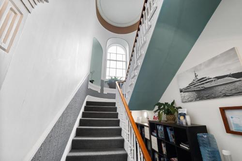 a staircase in a house with a boat on the wall at Imperial Plymouth in Plymouth