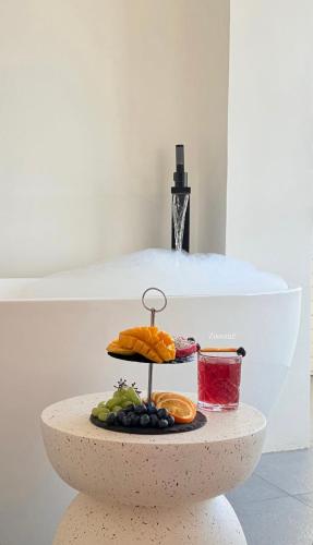 a plate of fruit on top of a table at zahr albun villa in Al Raka