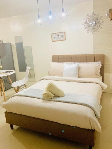 a bedroom with a large bed with white sheets and pillows at Asahel Cozy Crib Budget studio with Netflix in Buri