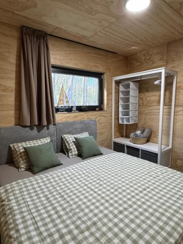 a bedroom with a large bed in a small room at Sunset hausbot in Bratislava