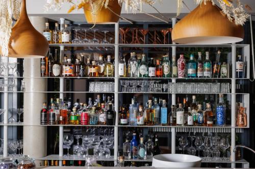 a bar filled with lots of bottles and glasses at Belaroïa Montpellier Centre Saint Roch in Montpellier