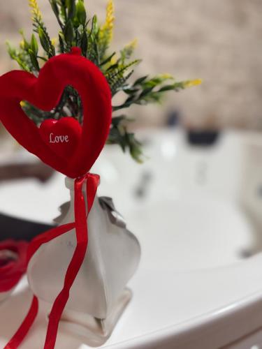 a red heart on a vase with a red ribbon at I CAVALIERI in Terlizzi