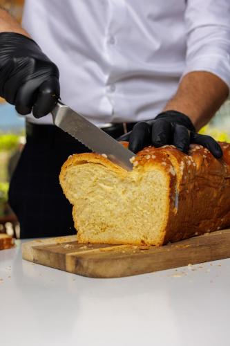 a person cutting a loaf of bread with a knife at Belaroïa Montpellier Centre Saint Roch in Montpellier