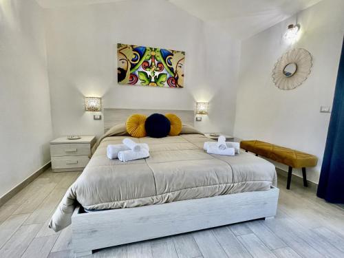 a bedroom with a large bed with two towels at I MORI - Holiday Rooms in Lascari