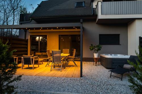 a patio with a table and chairs and a hot tub at Apartments Villa Prod in Ljubljana