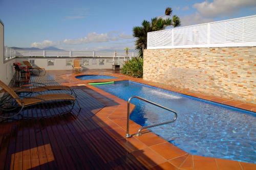 a swimming pool on top of a building at Cairns Central Plaza Apartment Hotel Official in Cairns