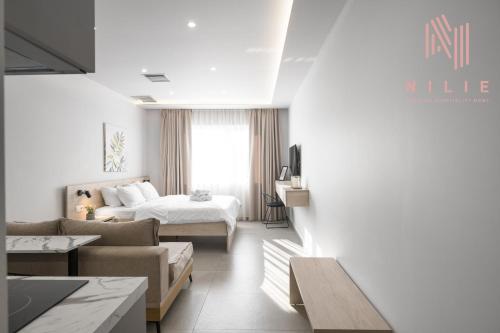 a hotel room with a bed and a living room at Pantheon, Nilie Hospitality MGMT in Thessaloniki