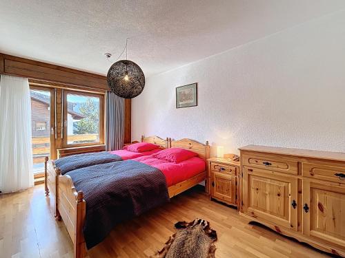 a bedroom with a bed and a dog laying on the floor at Chottelaine 002 in Verbier