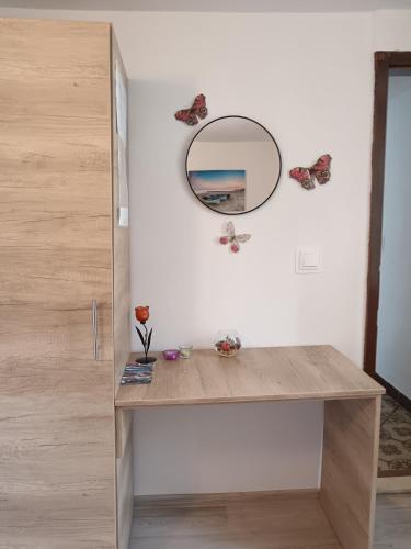a room with a desk with a mirror and butterflies at Studio apartment Dragana in Babino Polje
