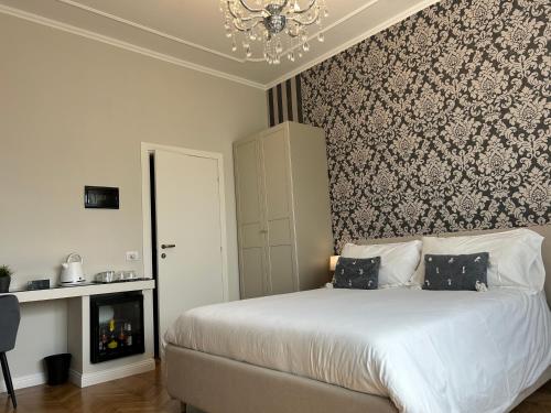 a bedroom with a bed and a chandelier at Villa Marchese Lake Maggiore in Somma Lombardo