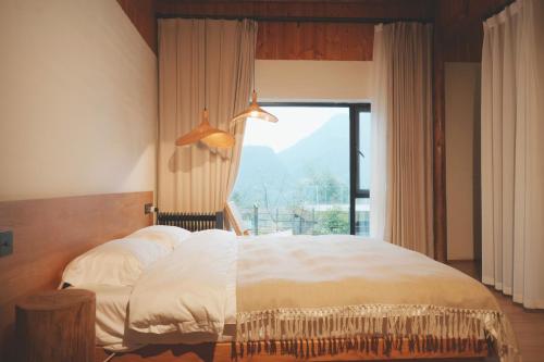 Postel nebo postele na pokoji v ubytování Chunqiu · Banshan Leisure Resort