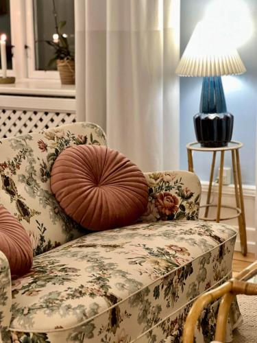 a living room with a chair and a lamp at Hotel Klostergaarden in Allinge