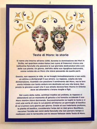 a poster with two portraits of a man and a woman at I MORI - Holiday Rooms in Lascari
