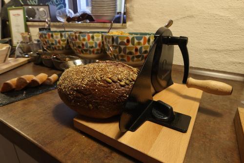 a loaf of bread on a cutting board with a knife at Boutique-Hotel Lohspeicher in Cochem