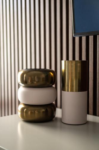a stack of rocks on a table next to a vase at Havatselet 19 By Isrentals in Jerusalem