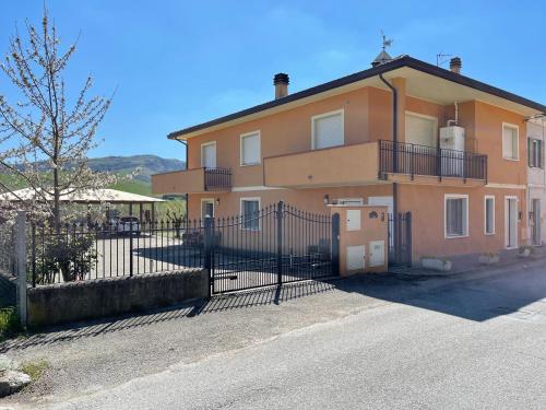 a large house with a fence in front of it at AGRITURISMO Ca' Maggio in Sassofeltrio