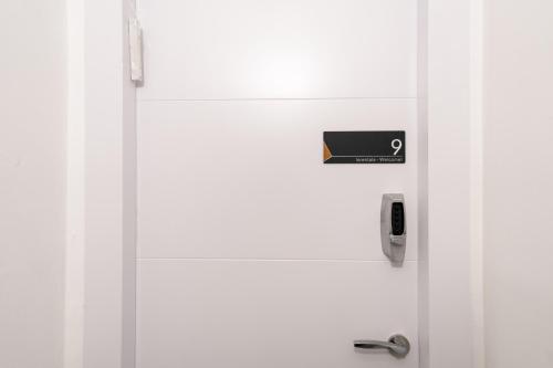 a door with a cell phone sticking out of it at Havatselet 19 By Isrentals in Jerusalem