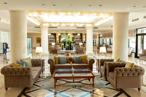 a lobby with couches and a coffee table at Rixos Montaza Alexandria in Alexandria
