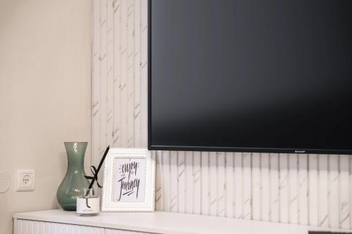 a flat screen tv sitting on top of a shelf at Havatselet 19 By Isrentals in Jerusalem