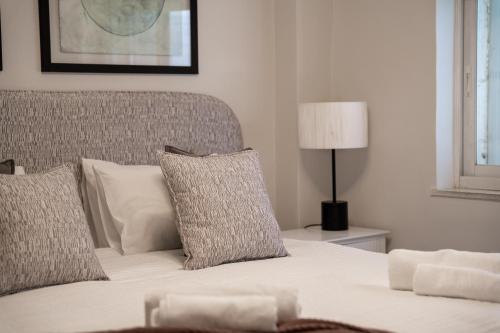 a bedroom with a bed with pillows and a lamp at Havatselet 19 By Isrentals in Jerusalem