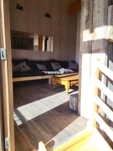 a living room with a bed and a couch at Maison de village in Eyne